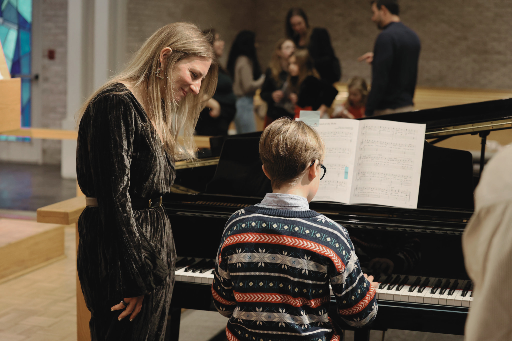Brooke Schrager assisting her student during a warm-up prior to his performance